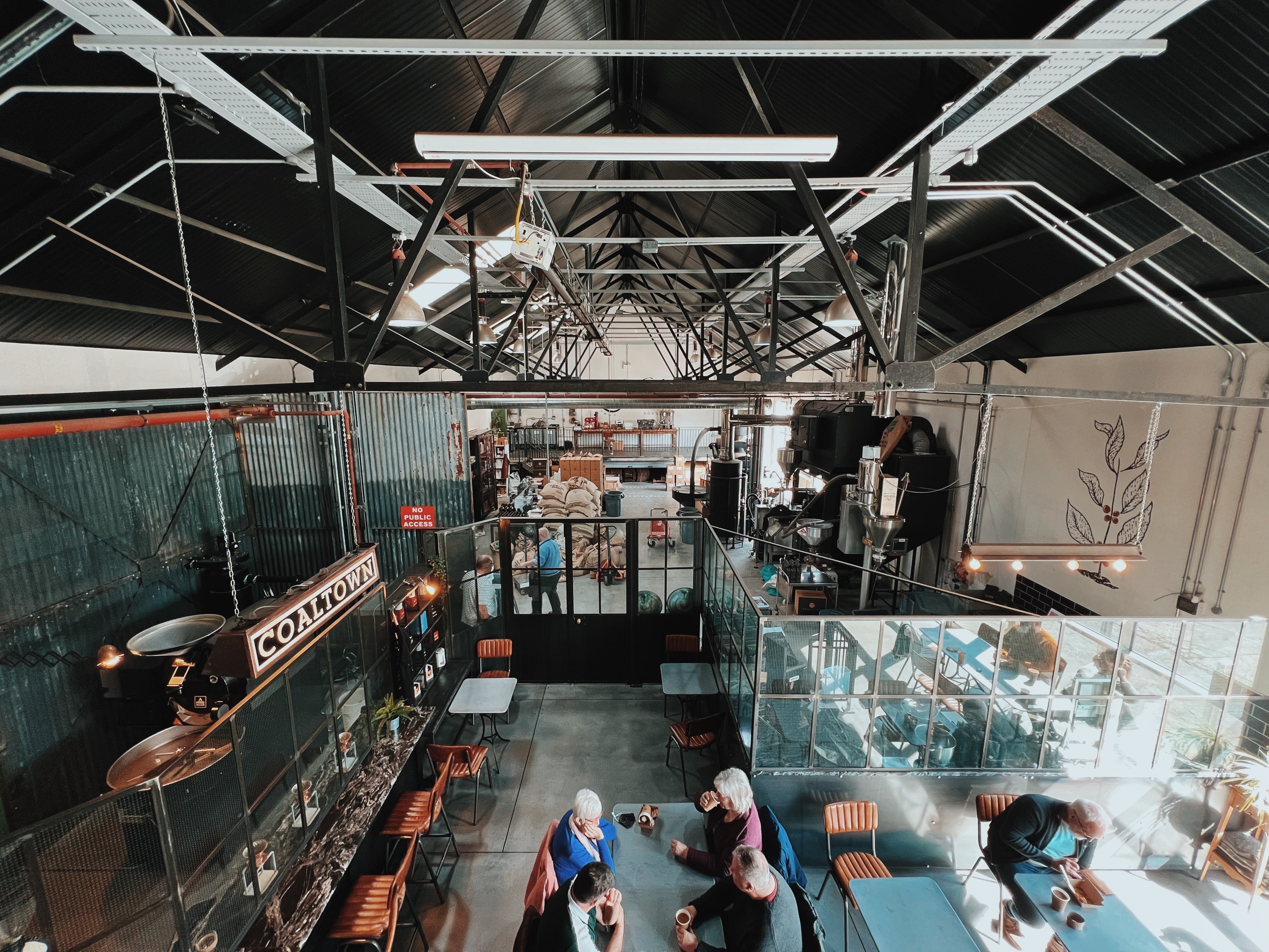 A view of Coaltown Coffee's Roastery and Espresso Bar, shot from the mezzanine
