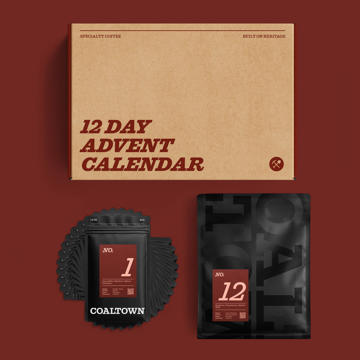 A 12-day Advent calendar coffee set by COALTOWN, featuring a large kraft card box labeled '12 DAY ADVENT CALENDAR' and 11 x 40g black coffee bags and 1 x 200g  bag, arranged on a dark red background.