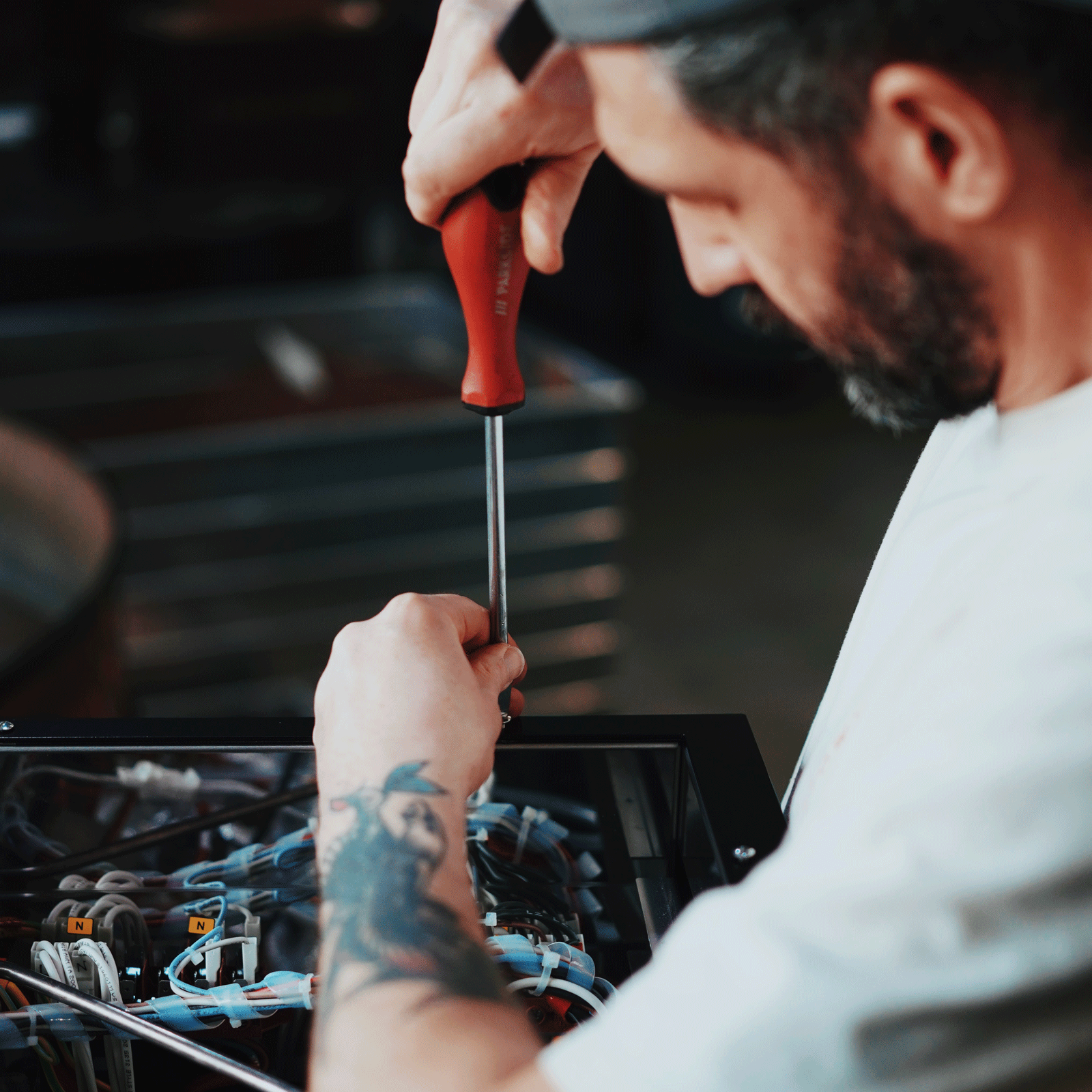 person fixing la marzocco machine in coaltowns roastery in ammanford.
