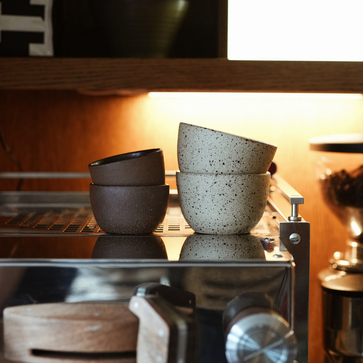 Flat White and Espresso Ceramic Coffee Cups Handmade Matt Jones Ceramics Collaboration, sitting on top of a la marzocco coffee machine 