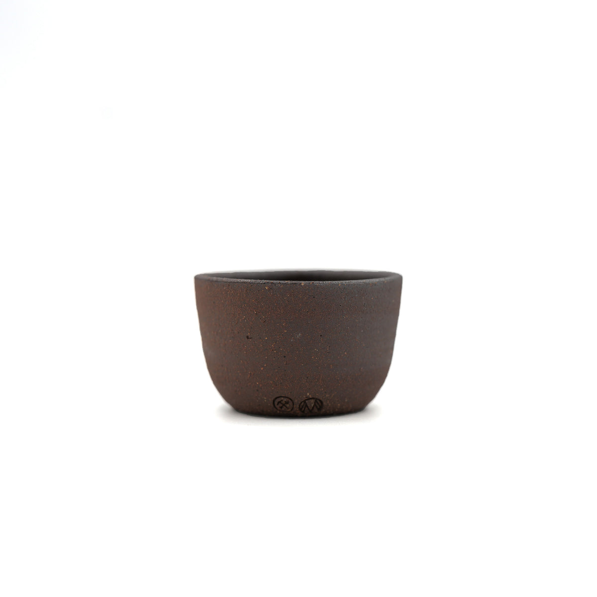 A small dark brown speckled ceramic cup with a matte finish, centered on a plain white background.