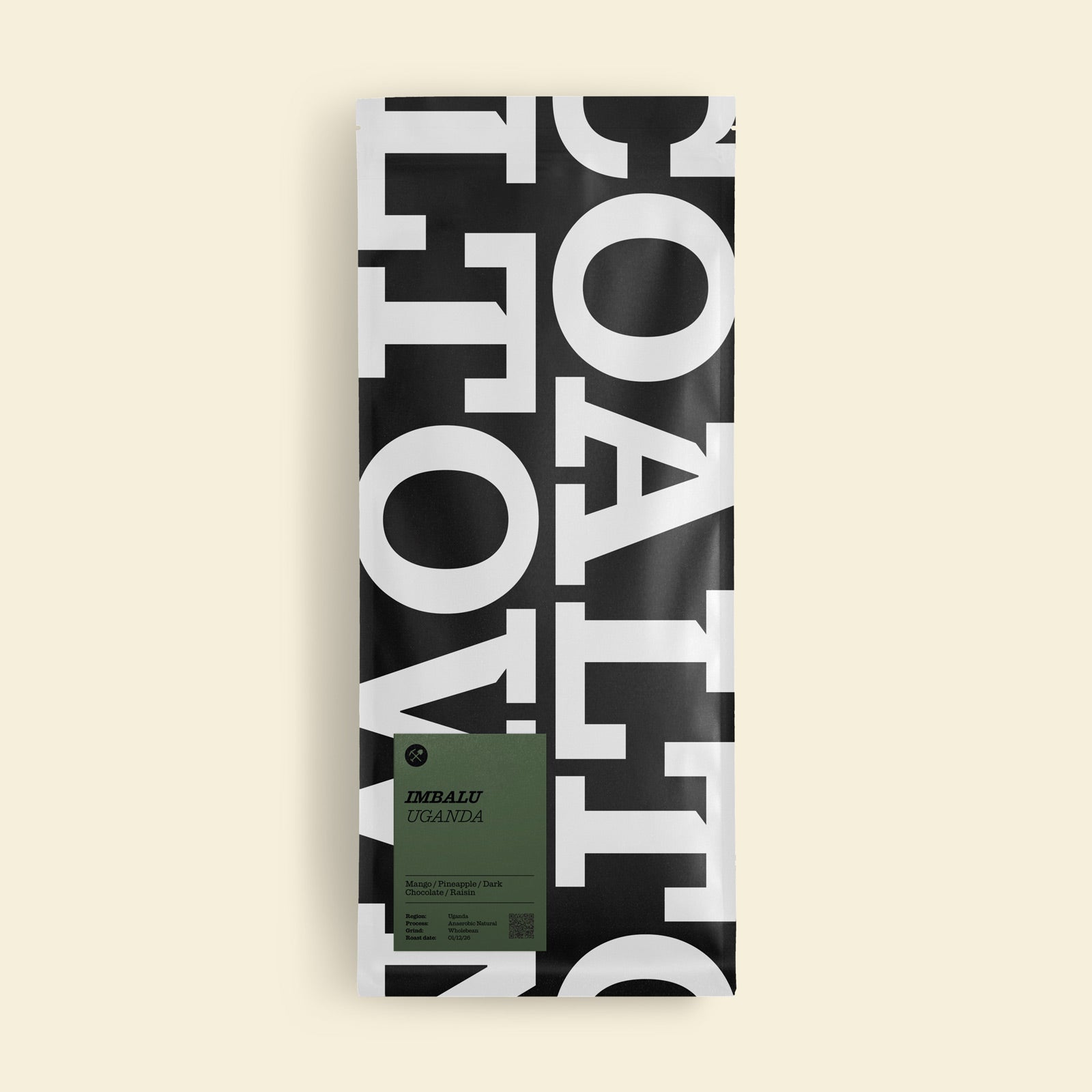 A tall rectangular package of Imbalu Organic coffee on a solid cream background. The 1 kilo bag features a bold black and white graphic Coaltown repeat pattern of vertical letters, with a muted olive green label near the bottom displaying the brand 'Imbalu Organic'.